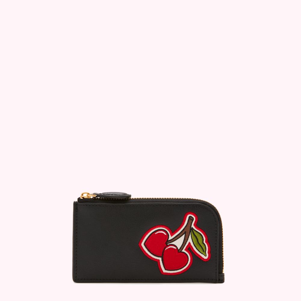 Black leather cardholder with a red cherry patch.