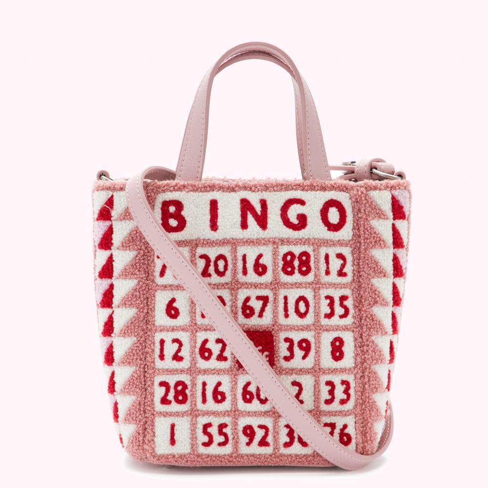 Pink bingo-themed handbag with a pink leather strap and numbers embroidered in red.