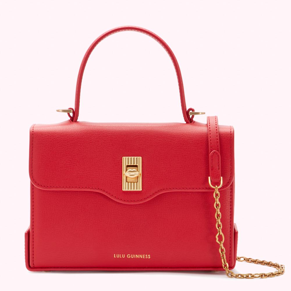 Red Lulu Guinness handbag with gold-toned hardware and chain strap.