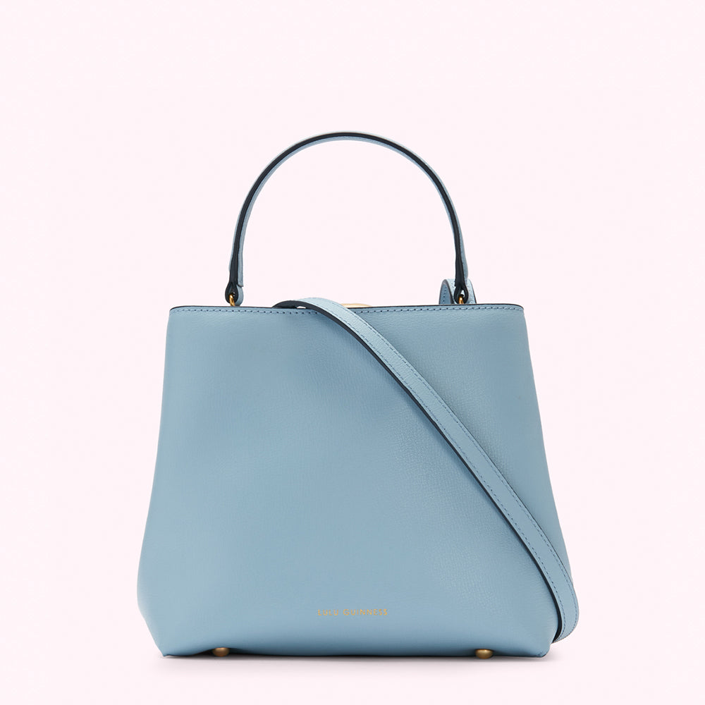 A pale blue structured handbag with a top handle and crossbody strap.