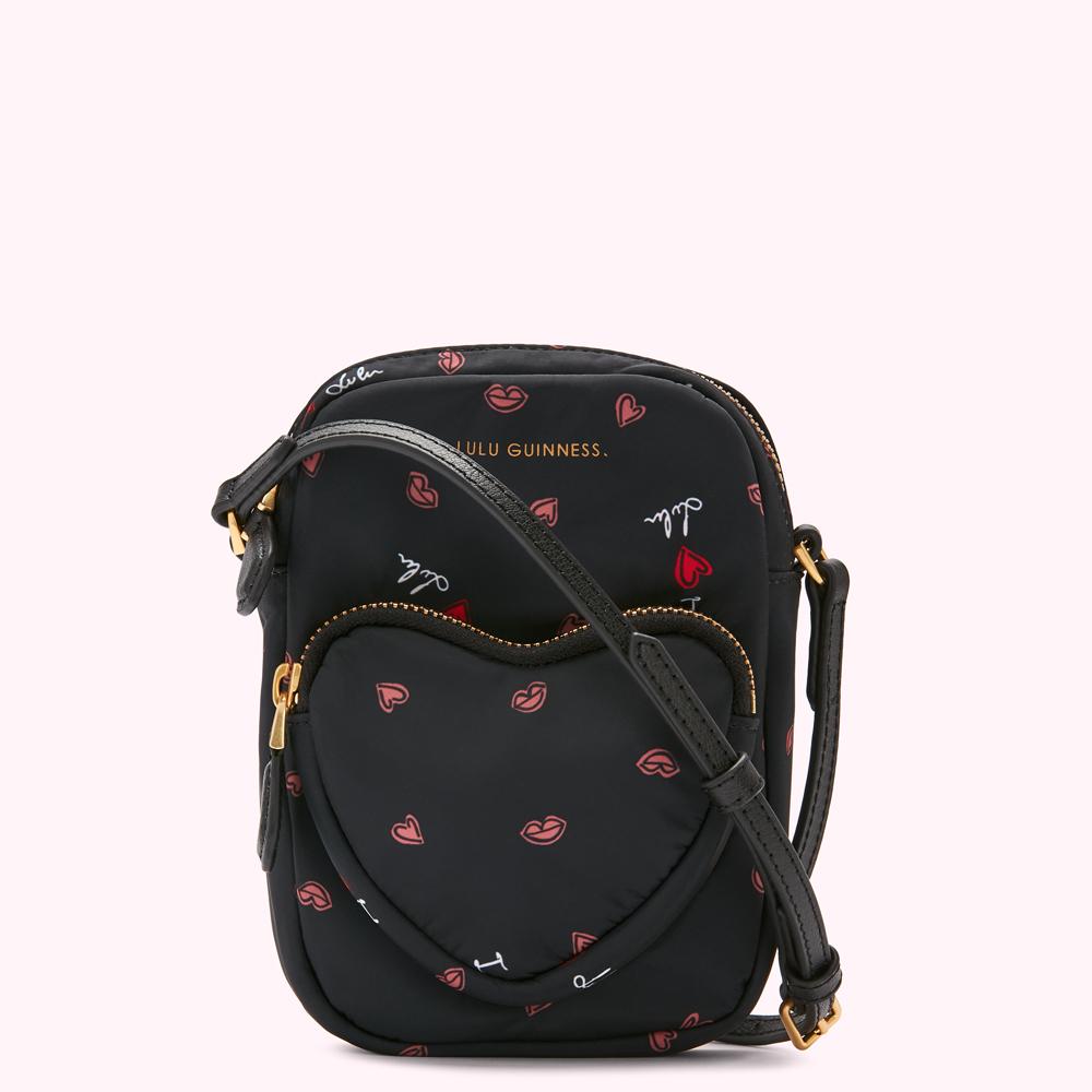 Black Lulu Guinness crossbody bag with red lips and hearts print.