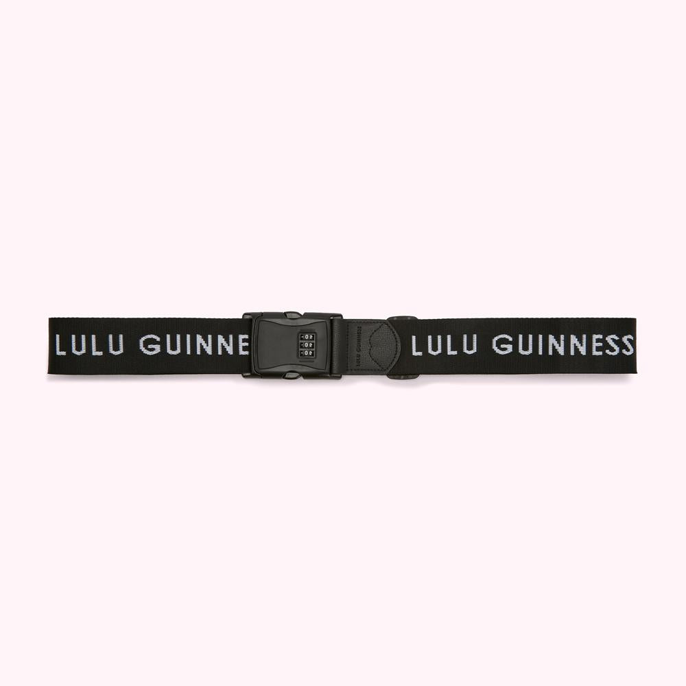 Black luggage strap with a combination lock and Lulu Guinness branding in white.