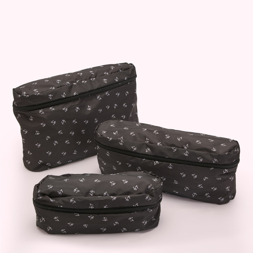 Three dark-grey zippered travel pouches of varying sizes, all with a repeating small white logo pattern, on a white background.