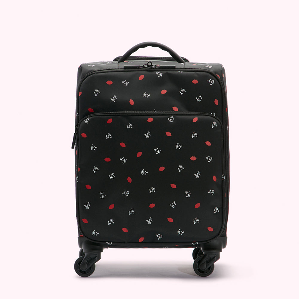 Black carry-on suitcase with a repeating pattern of red lips and white "LG" logos.