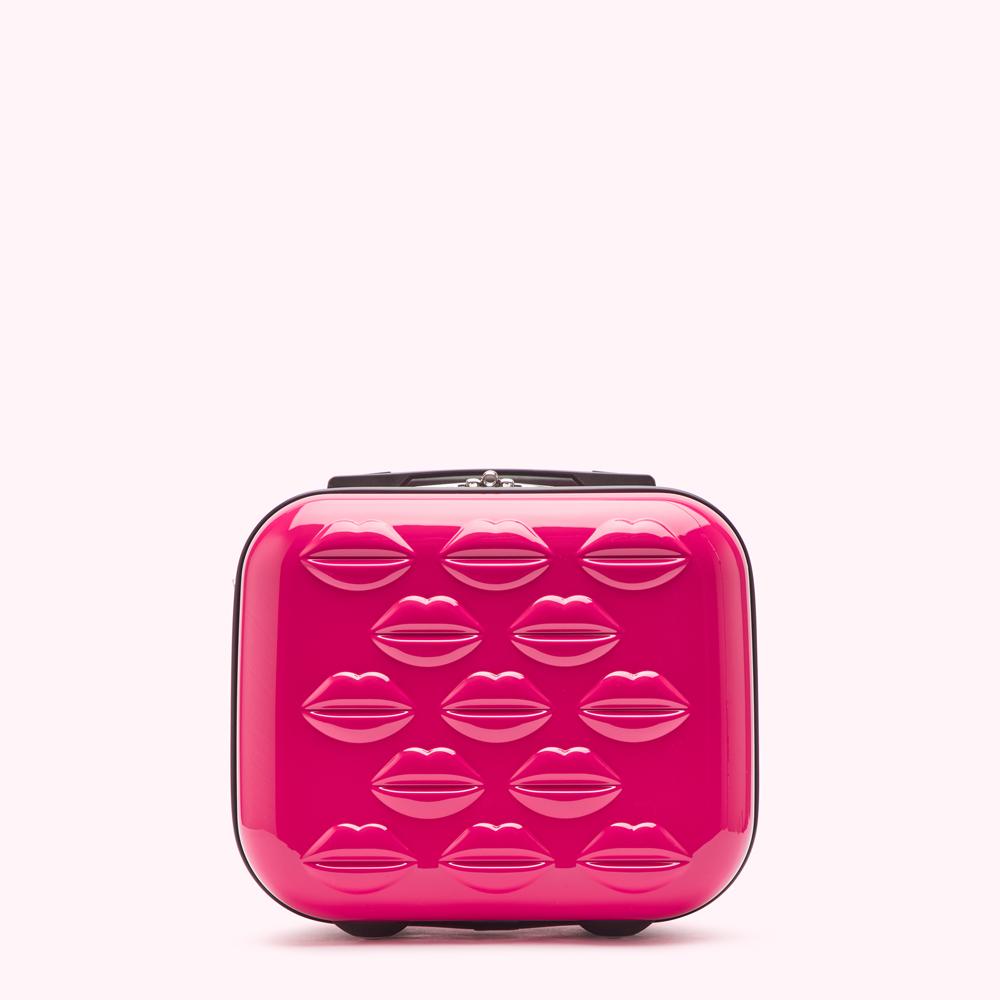 Pink carry-on suitcase with lip print design.