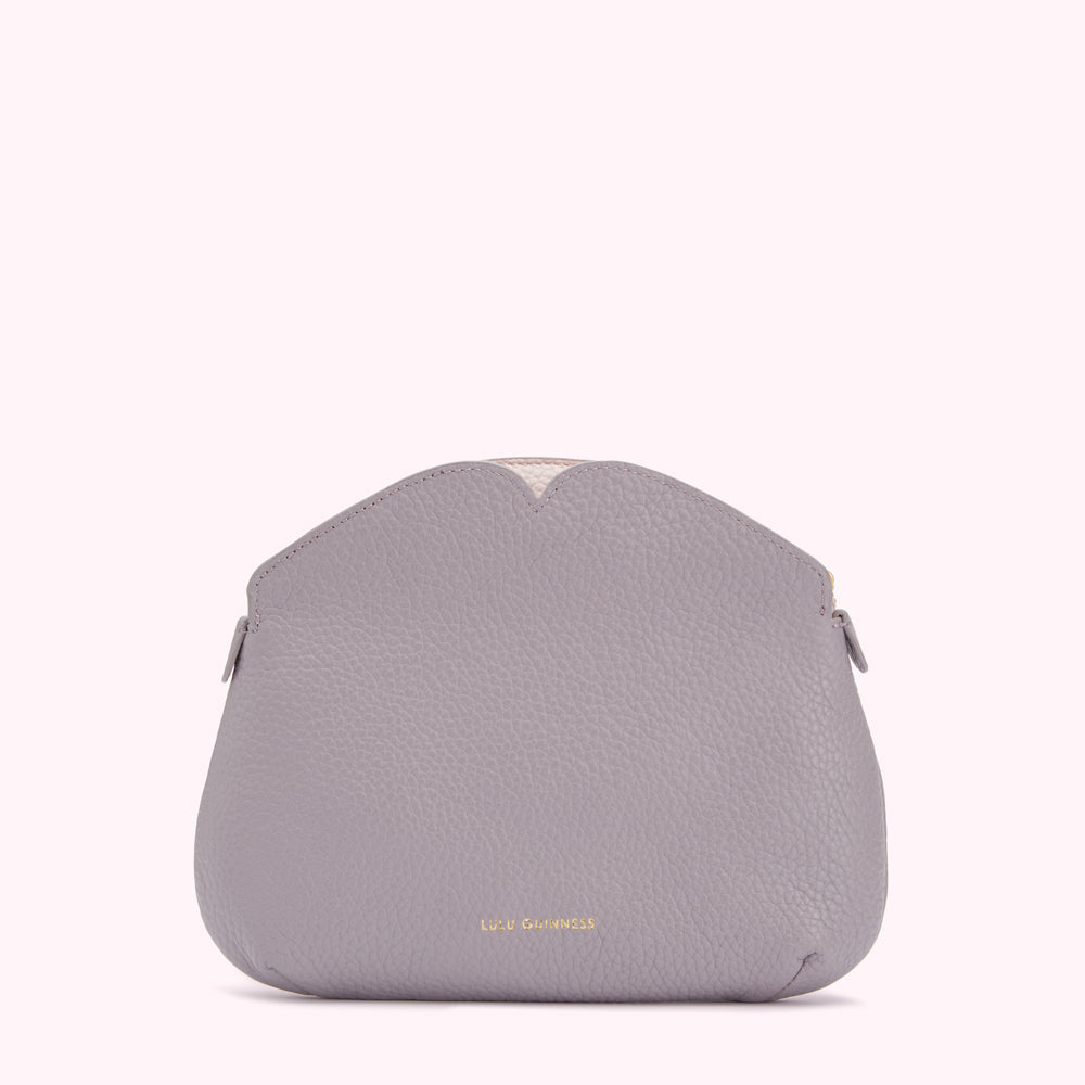 A gray Lulu Guinness purse with a heart-shaped top detail against a white background.
