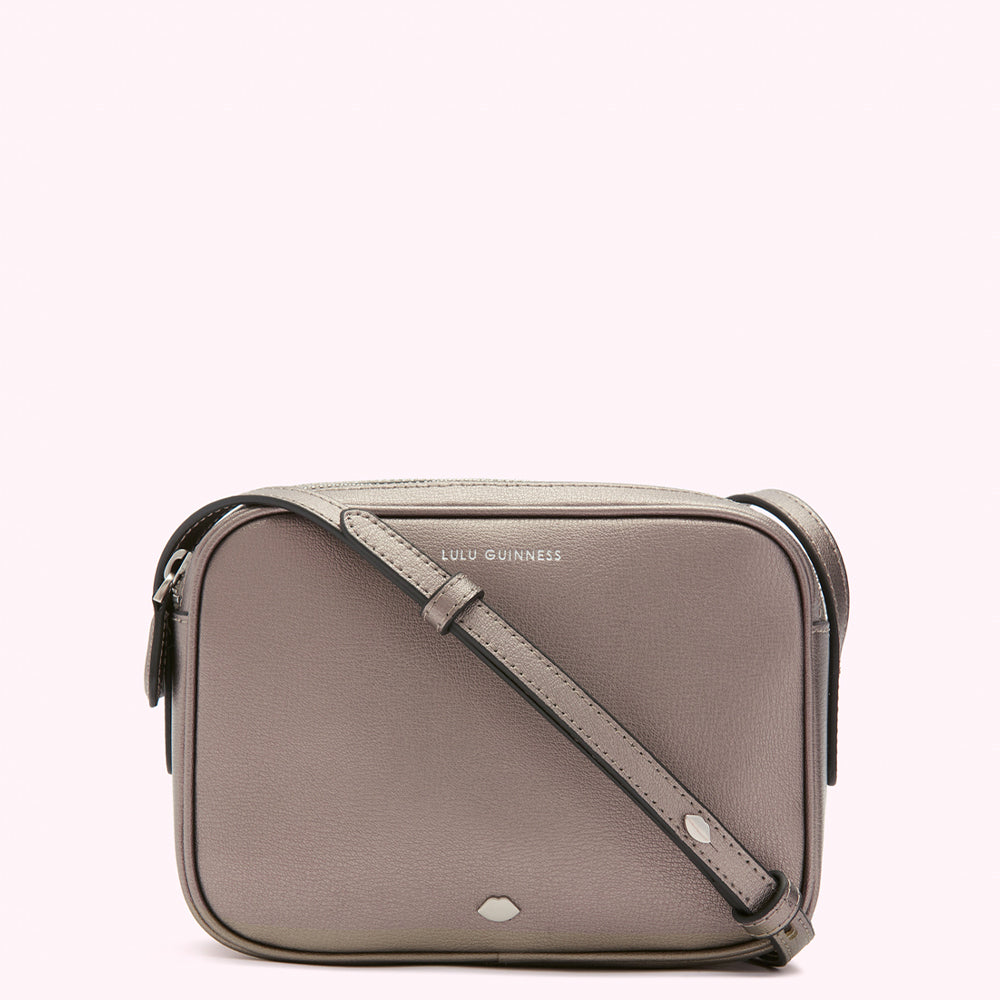 A silver Lulu Guinness crossbody bag with a long strap.
