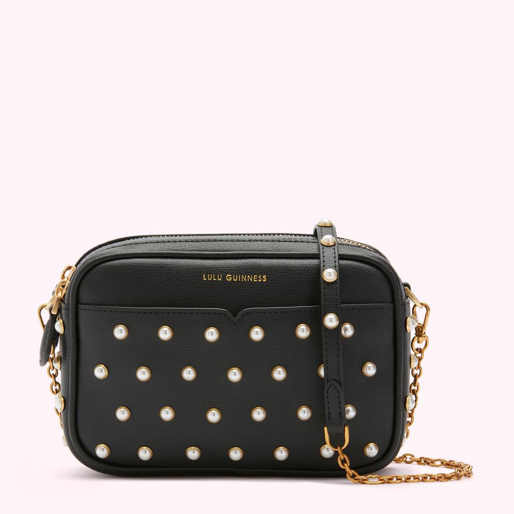 Black Lulu Guinness crossbody bag adorned with pearl embellishments and gold chain strap.