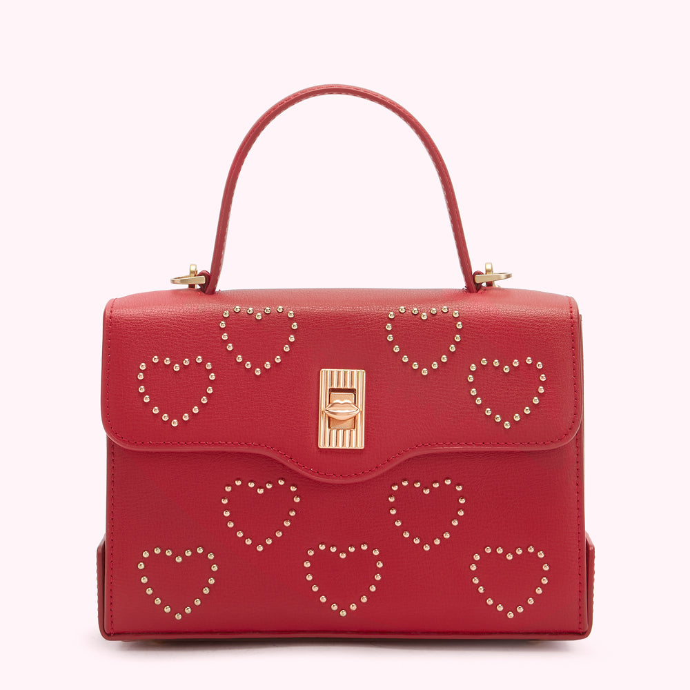 Red leather handbag with gold heart details and a gold clasp.