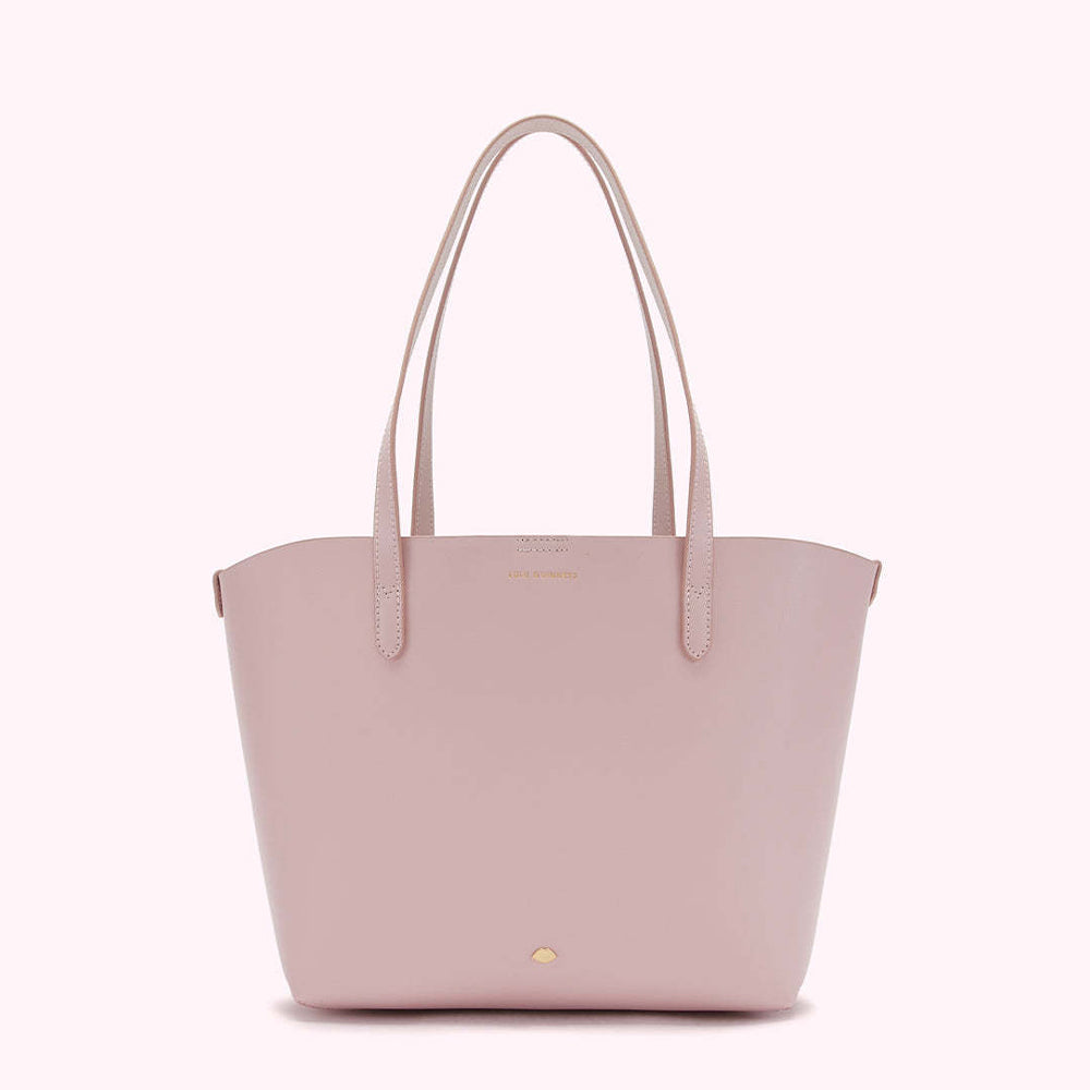 A pale pink leather tote bag with light-colored straps and subtle branding.