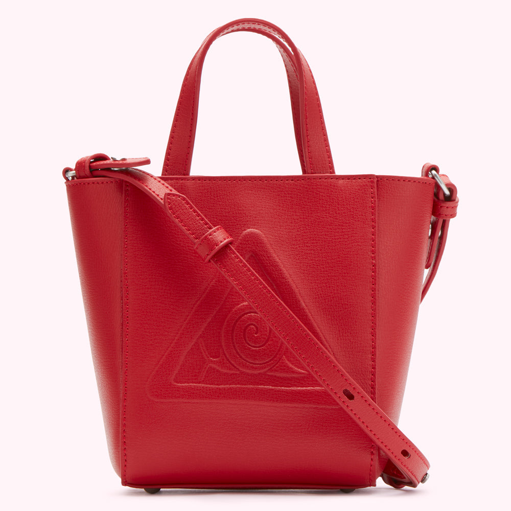 Red leather tote bag with embossed triangle and shoulder strap.