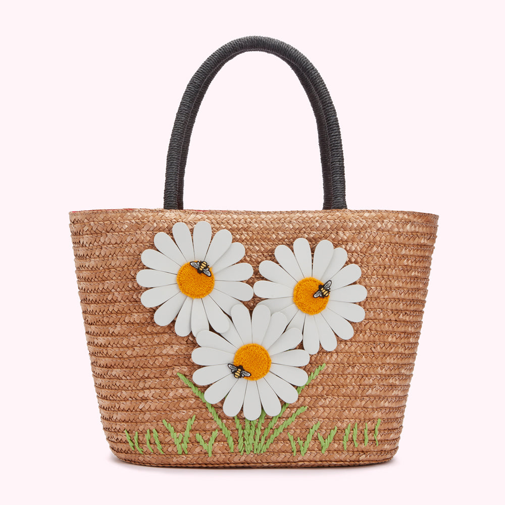 Tan straw tote bag with three white daisies and bees appliqué and green embroidered stems.
