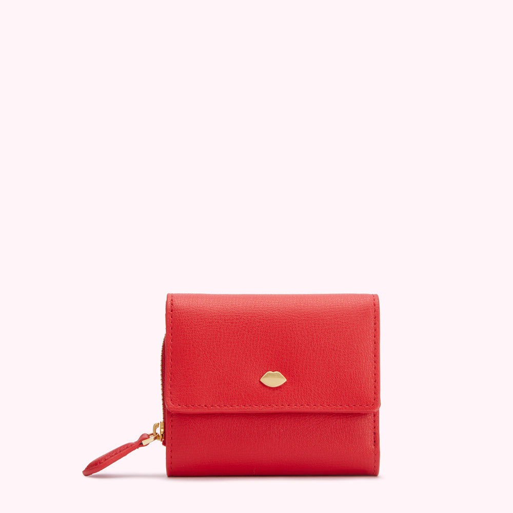 Red leather wallet with gold lip detail on a white background.