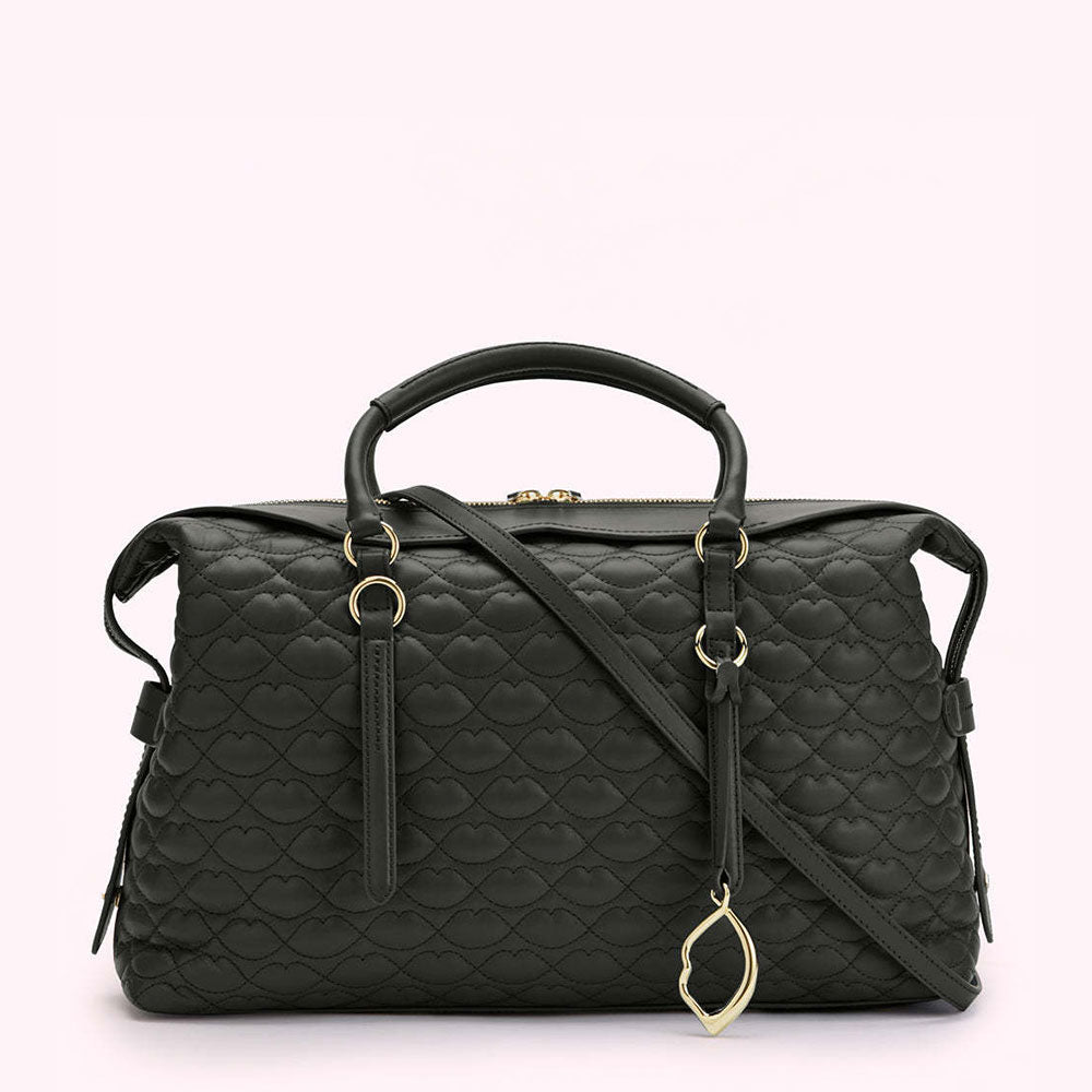 Black quilted handbag with gold accents and a crossbody strap. The quilting is in the shape of lips.