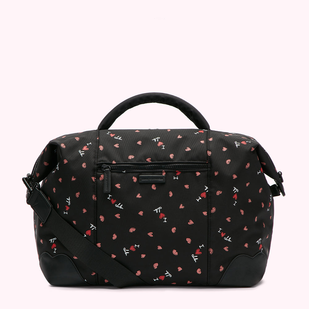 Large bag with a black background and a pattern of red hearts and the text "I love" repeated across it.