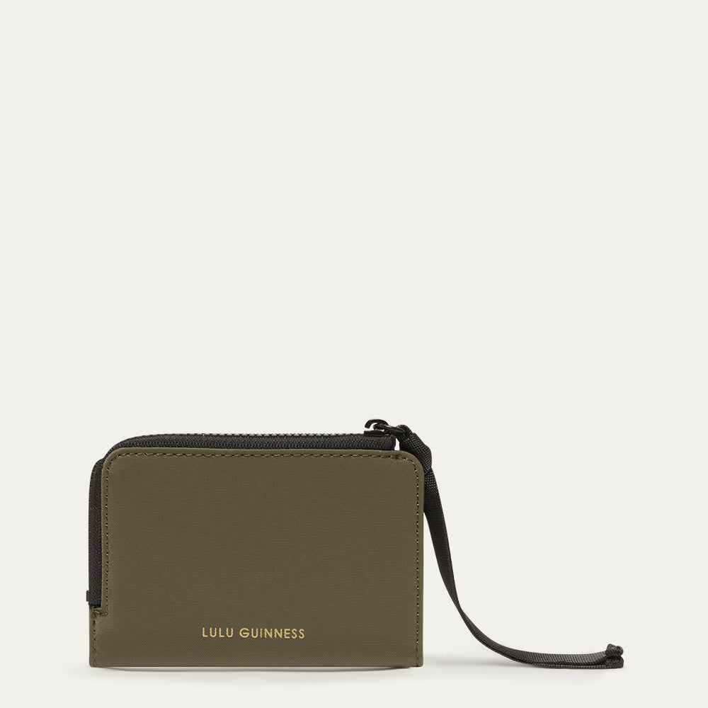 Green wallet with a black ribbon zip pull on a white background, featuring the Lulu Guinness logo.
