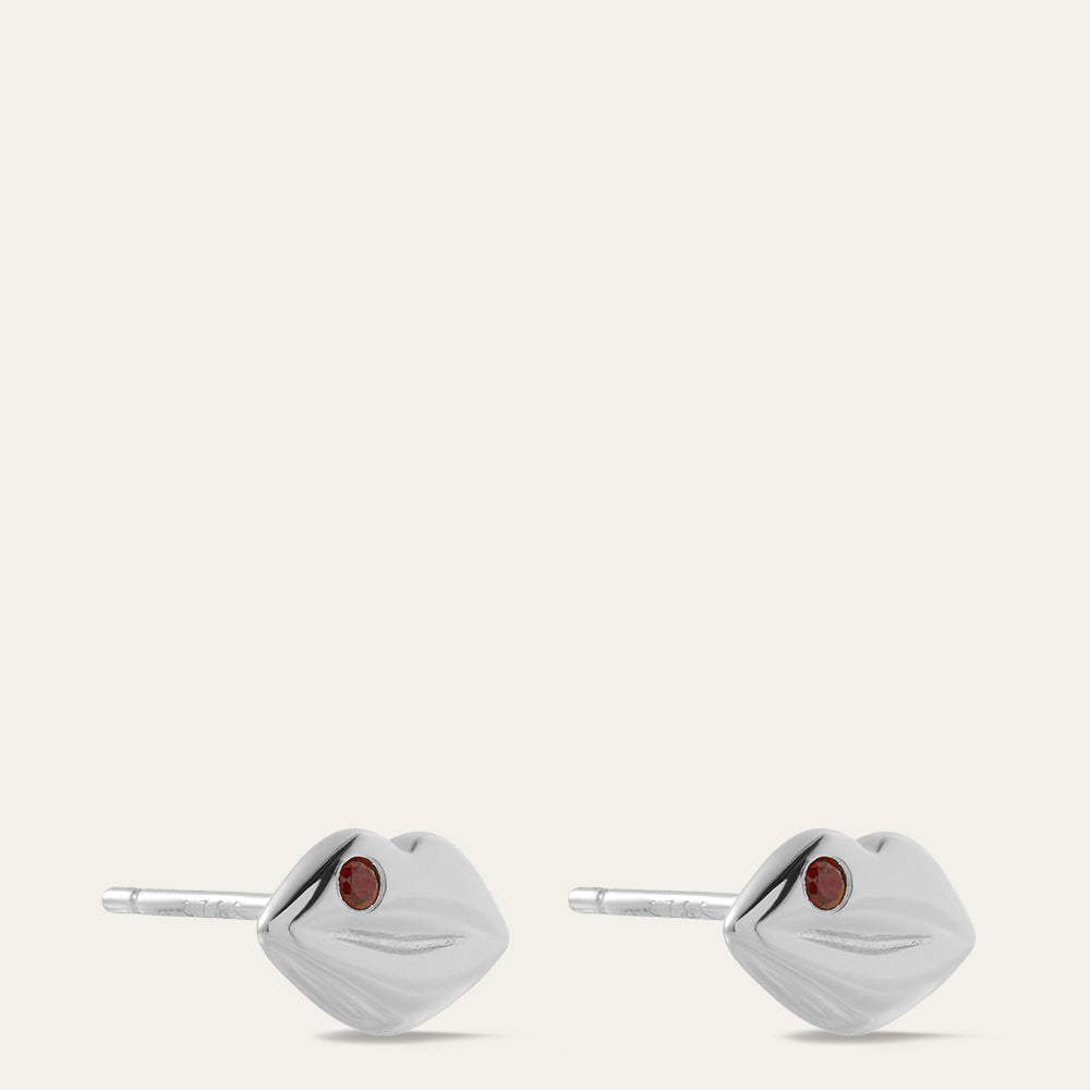 Pair of silver earrings with red gemstones on a white background