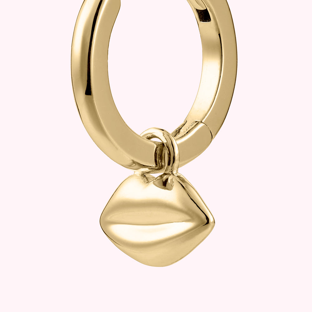 Close up image of a gold plated sterling silver hoop earring with lip charm.