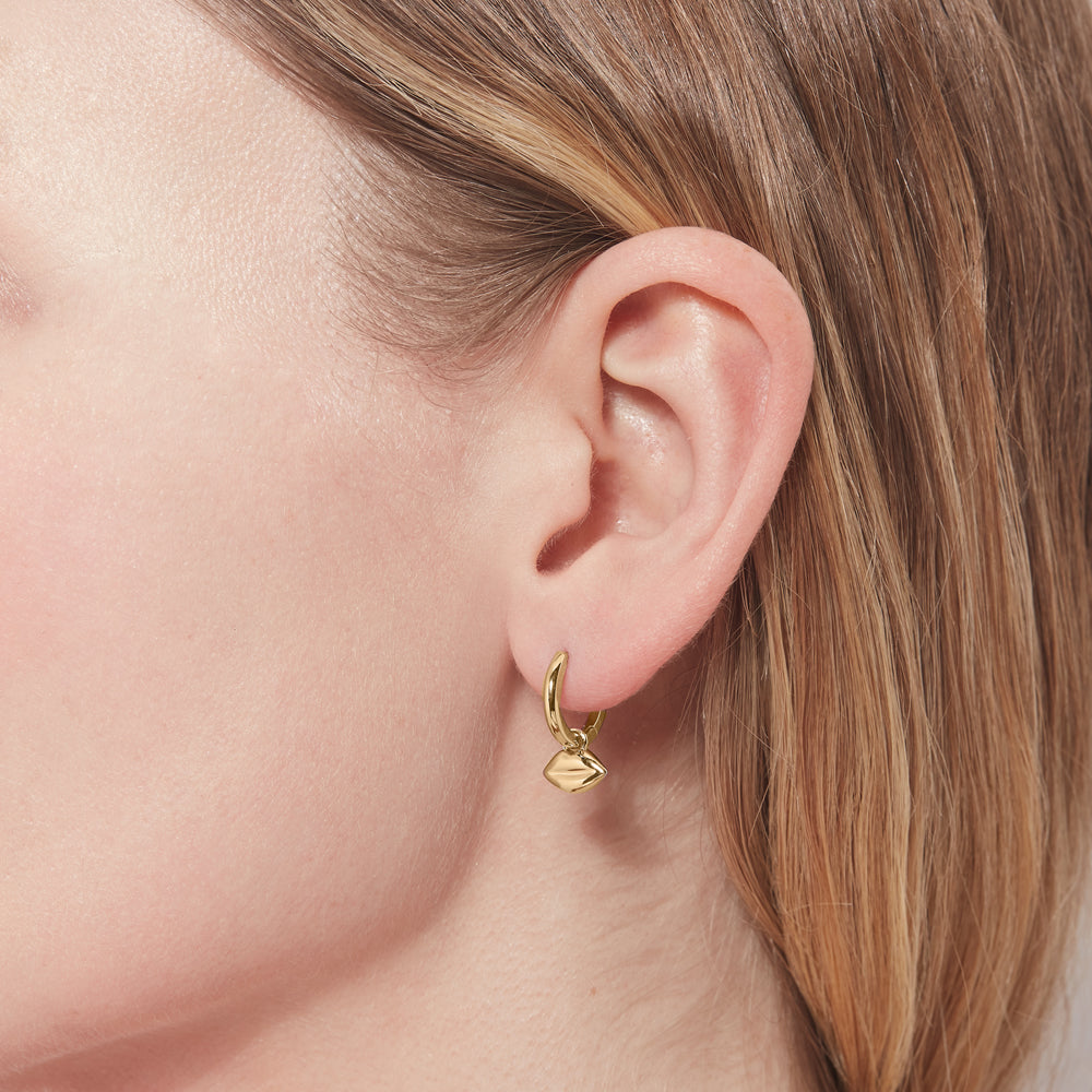 Gold plated sterling silver hoop earring with lip charm being worn.