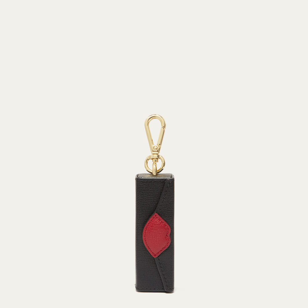 Black and red keychain with gold clasp on a light gray background