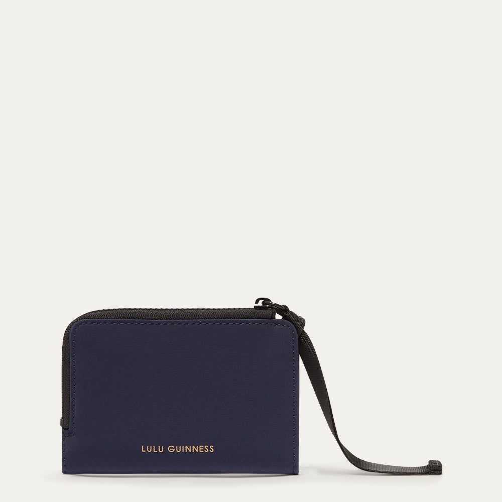 Navy blue wallet with a black ribbon zip pull on a white background, featuring Lulu Guinness branding.