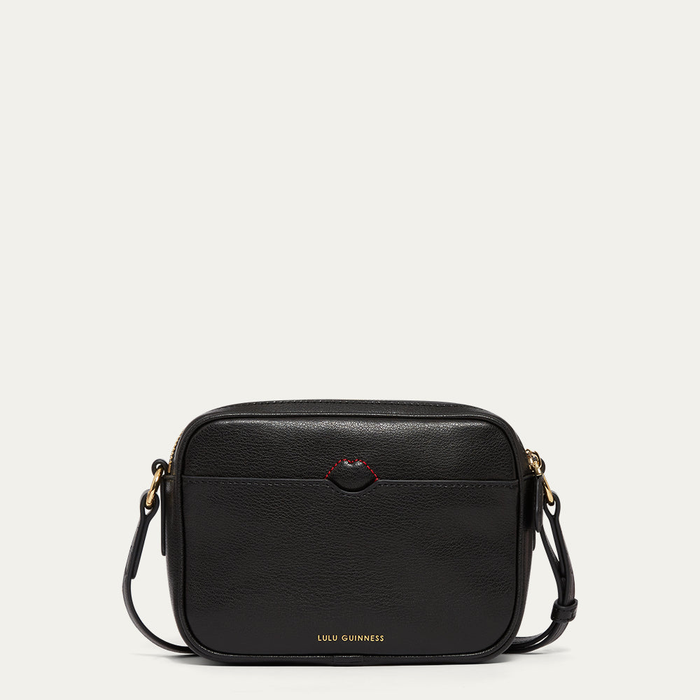Black handbag with gold accents, red stitching and gold Lulu Guinness logo on a white background