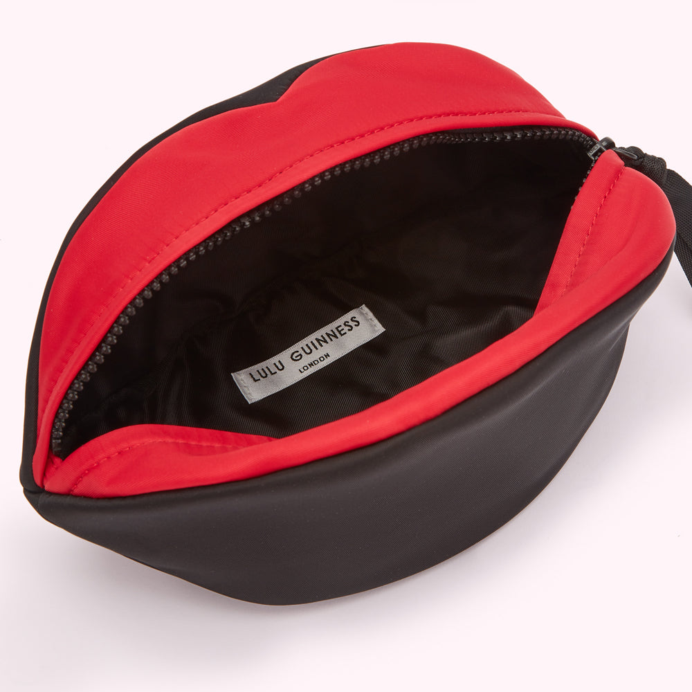 Open black and red Lulu Guinness makeup bag shaped like a pair of lips.