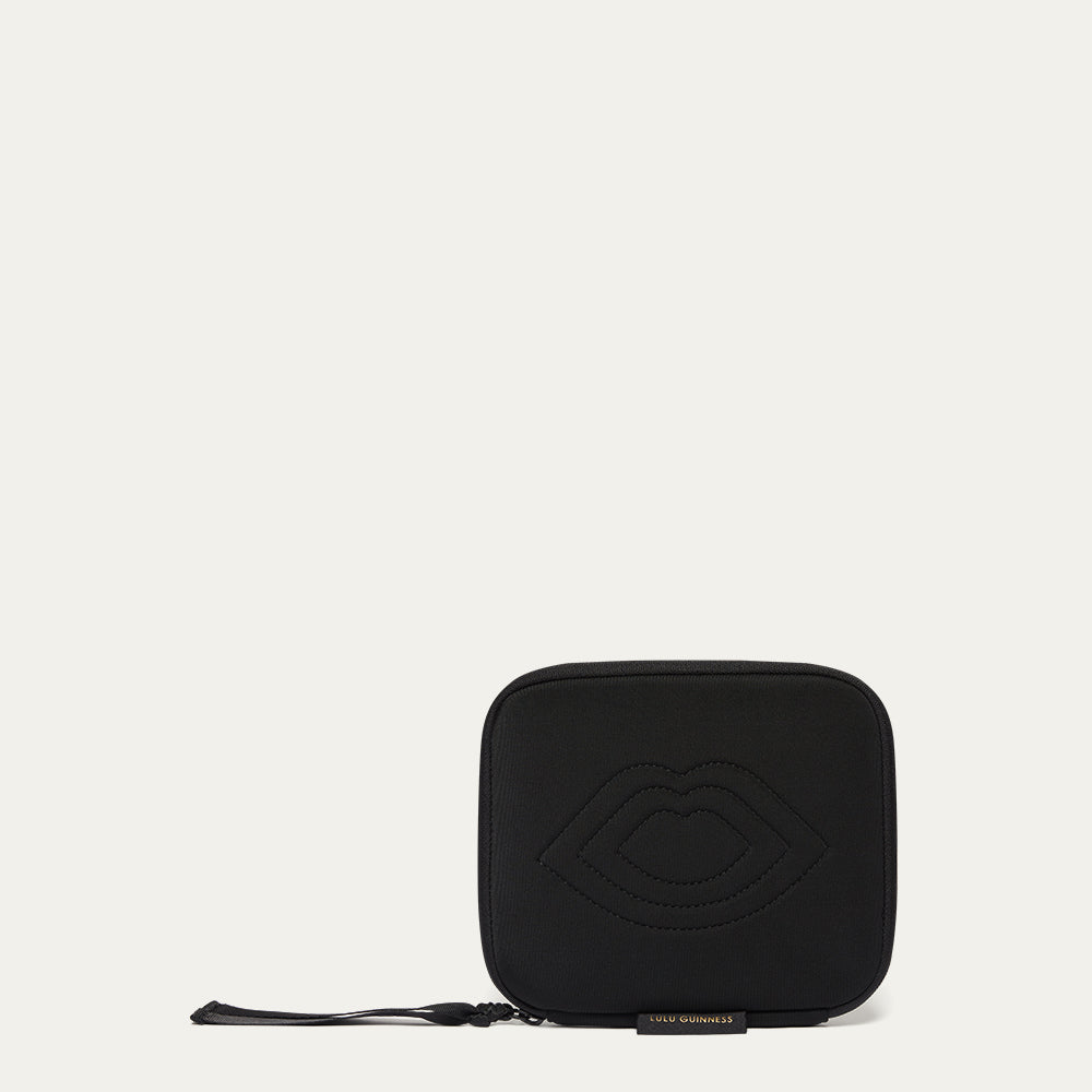 Black pouch with lip shaped quilting and a 'Lulu Guinness' logo on a white background