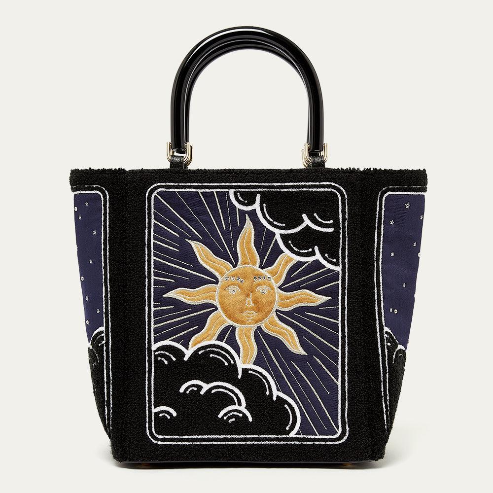 Handbag with sun and moon design on a white background