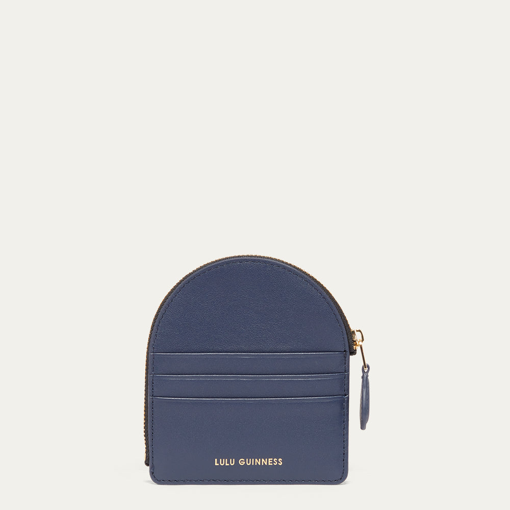 Blue coin purse with gold zipper on a light gray background