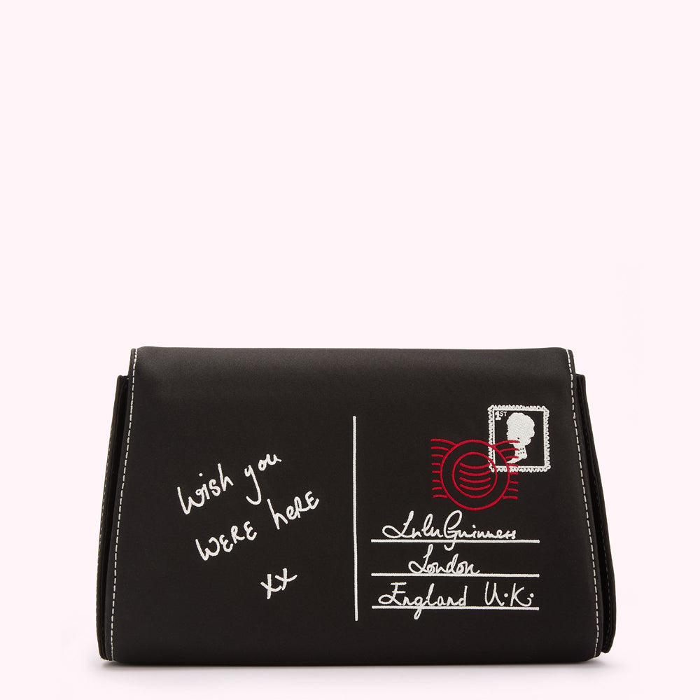 Black clutch with white stitching and embroidered postcard design. The postcard features the message "Wish you were here xx" and an address reading "Lulu Guinness, London, England U.K."
