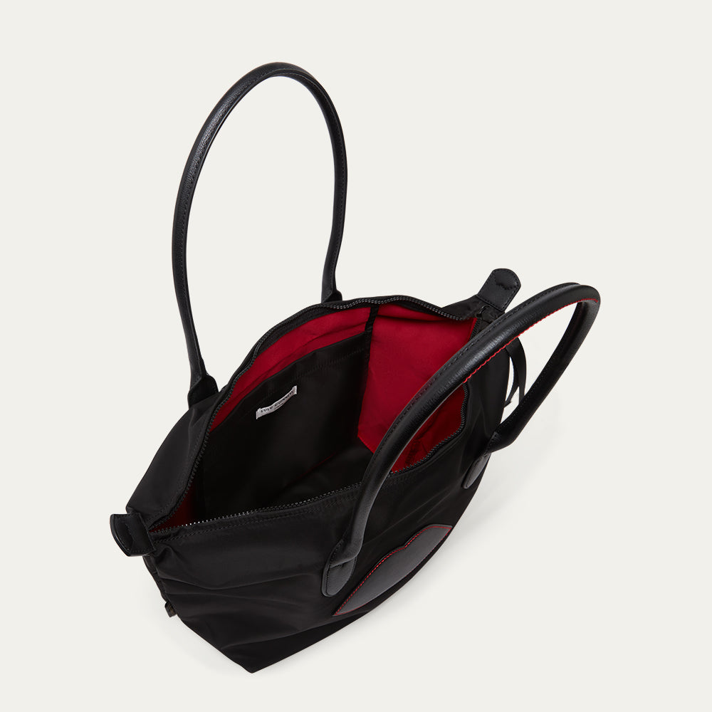 Black bag with lip detail open to reveal the inside pocket on a light grey background