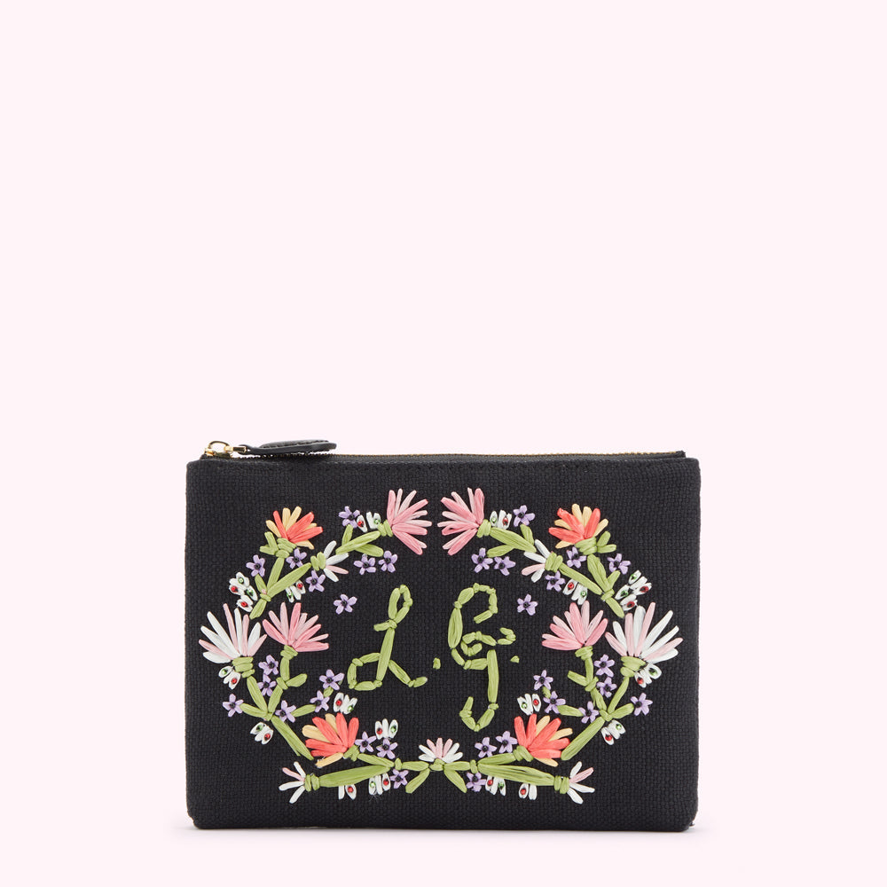 Front image of a black canvas pouch with pastel floral emobroidered detai land embroidered L.G. monogram.