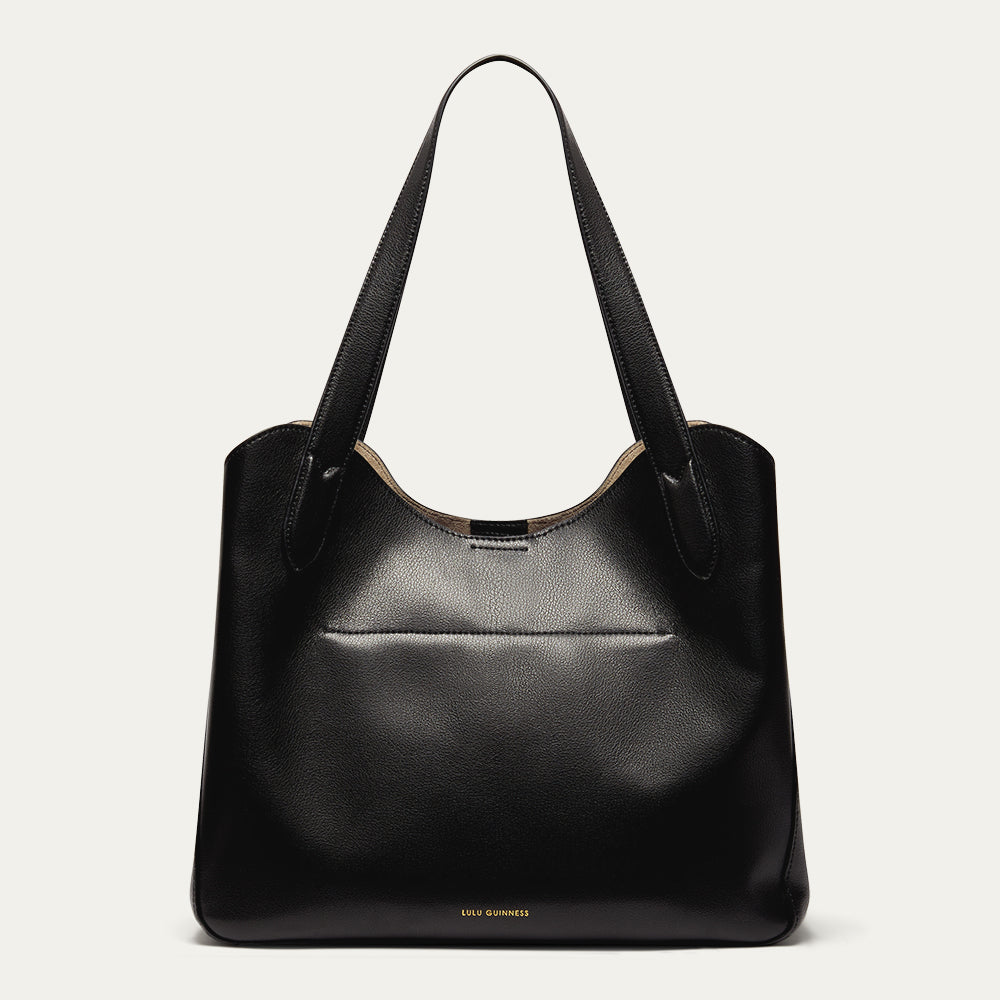 Black leather handbag on a light gray background