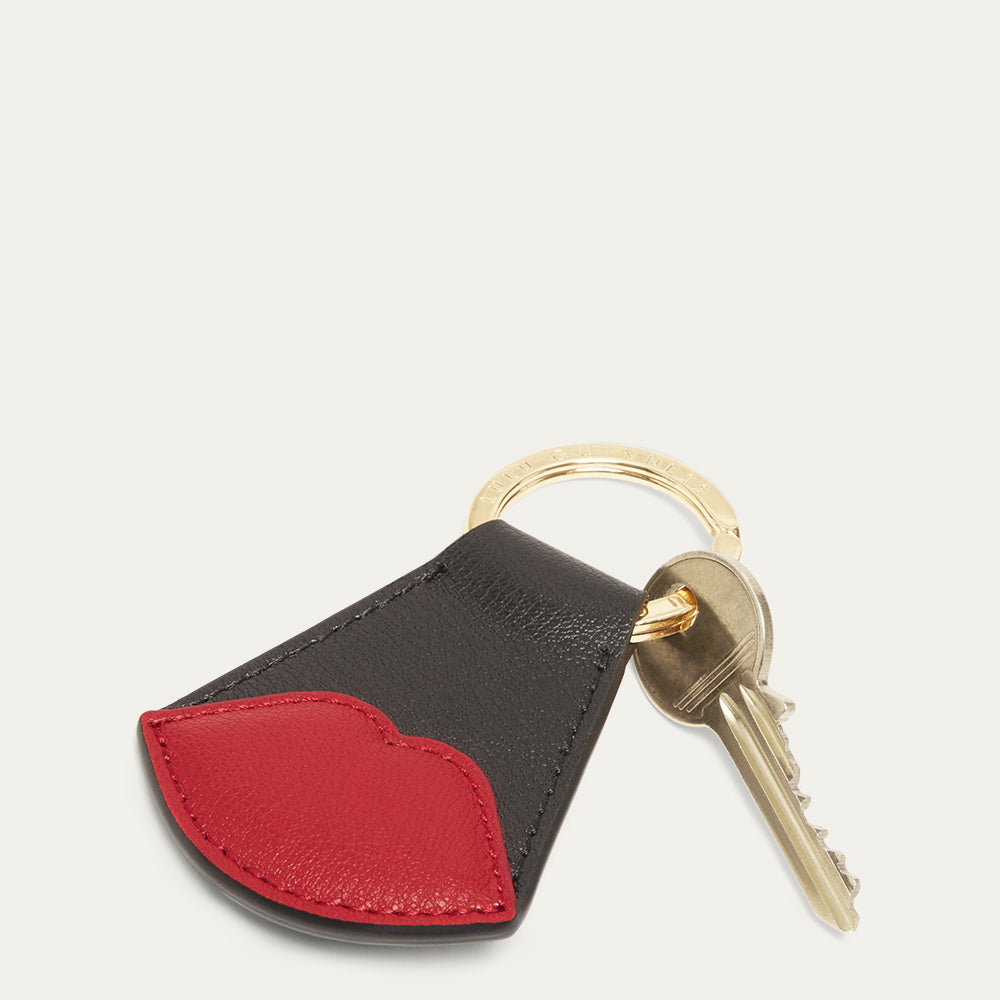 Keychain with black and red leather design on a white background.