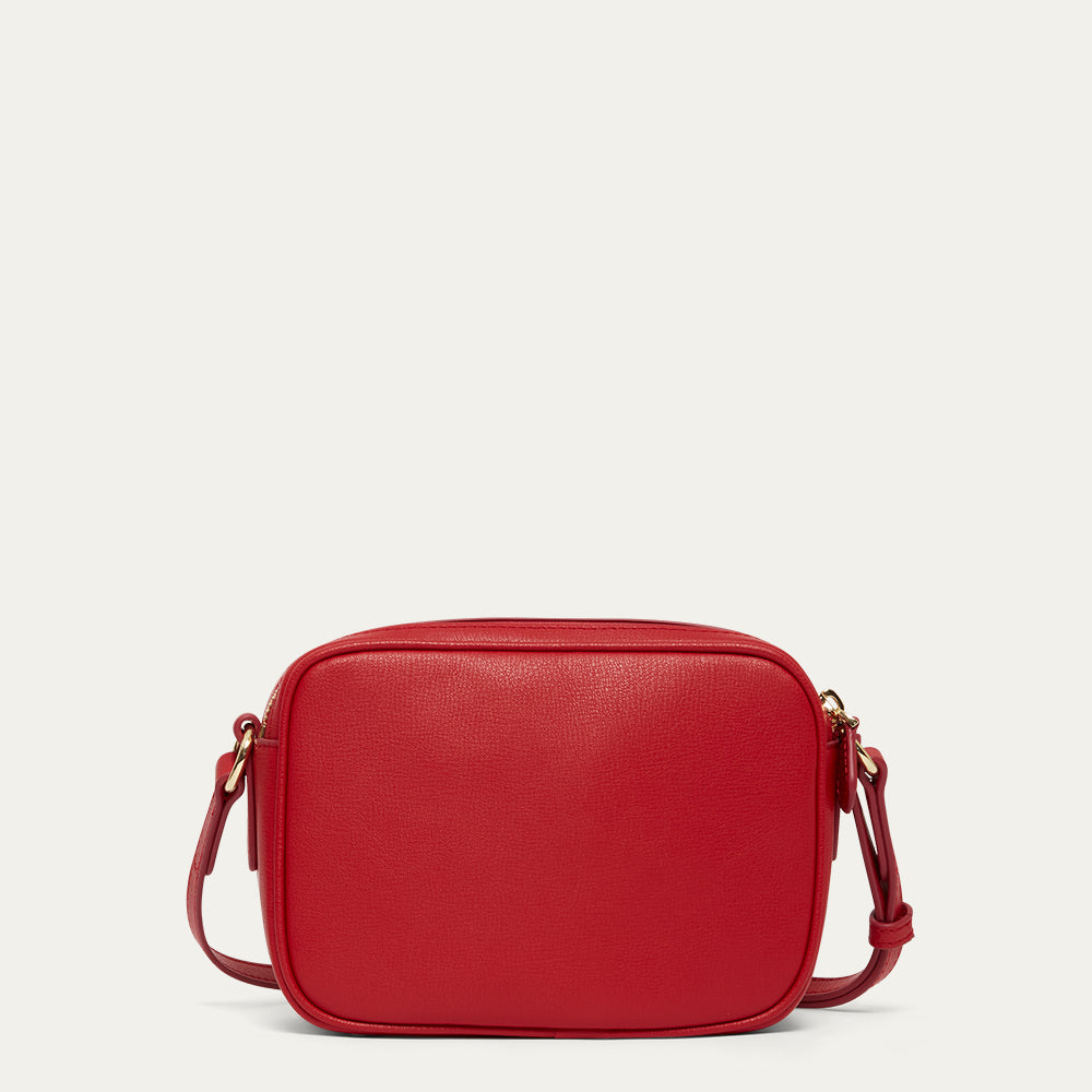 Red crossbody bag on a light beige background
