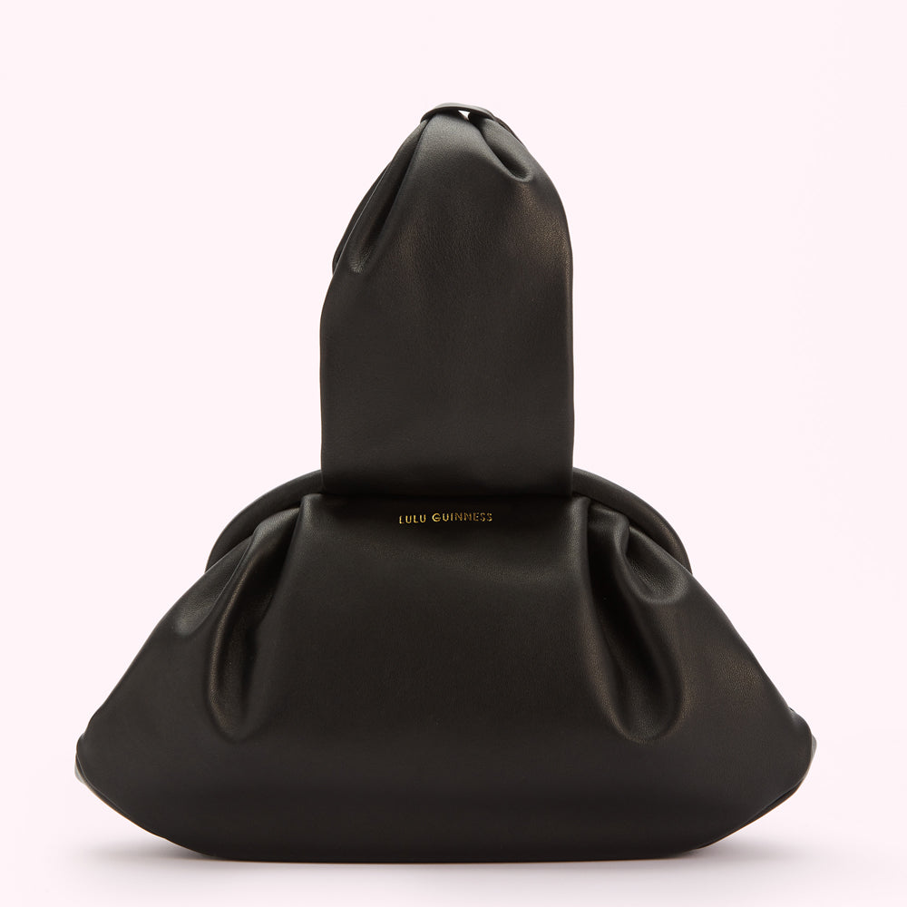 Black Lulu Guinness handbag with gathered detailing and a top handle.
