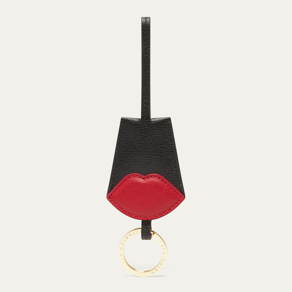 Keychain with black and red design on a light gray background