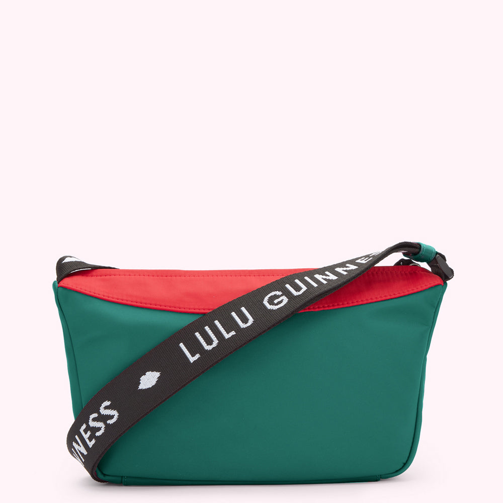 Green, red and black nylon crossbody bag with "Lulu Guinness" printed on the strap.