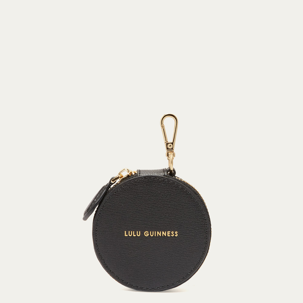 Black round keychain pouch with gold clasp and 'Lulu Guinness' branding on a white background