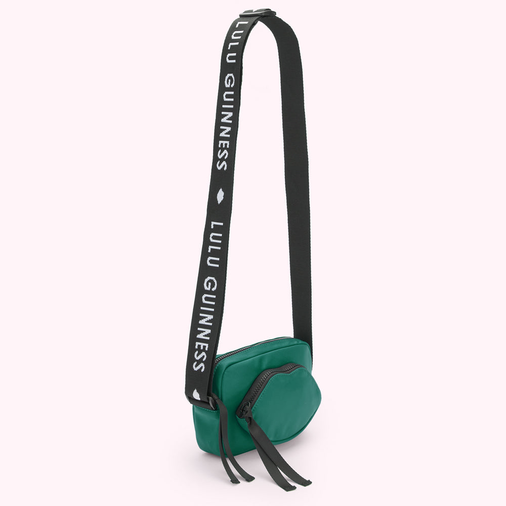 Green Lulu Guinness crossbody bag with black strap.