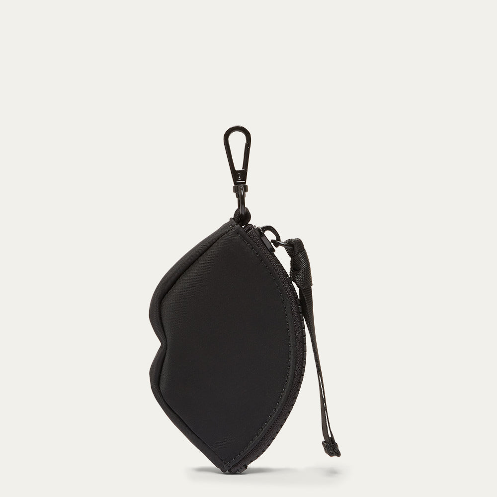 Black lip shaped charm on a light gray background