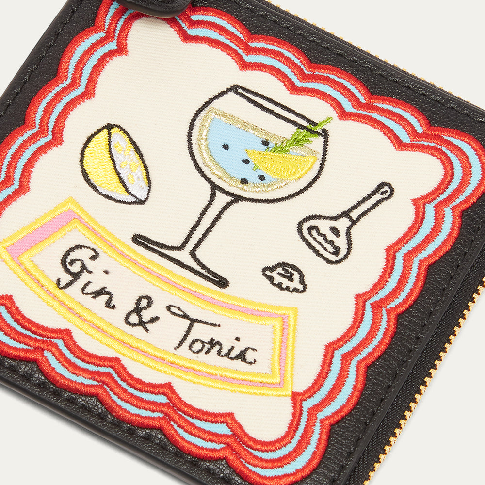 Close up image of embroidered 'Gin & Tonic' design on a coin purse.
