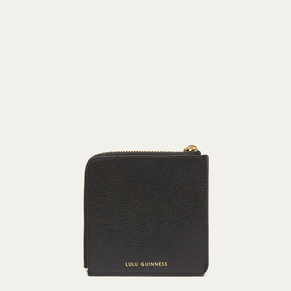 Black wallet with gold zipper and 'Lulu Guinness' branding on a white background