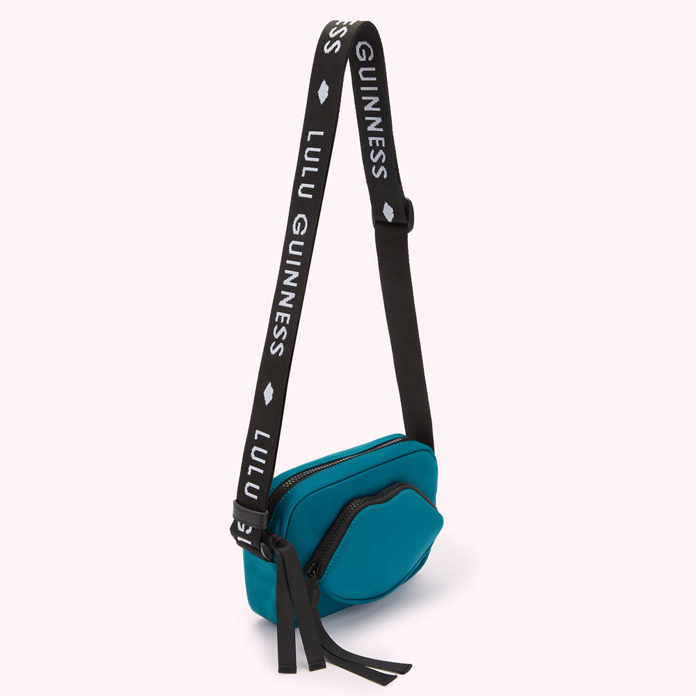 Teal Lulu Guinness crossbody bag with black strap.