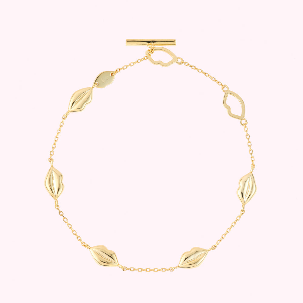 Gold plated sterling silver lip charm bracelet with lip shaped links.