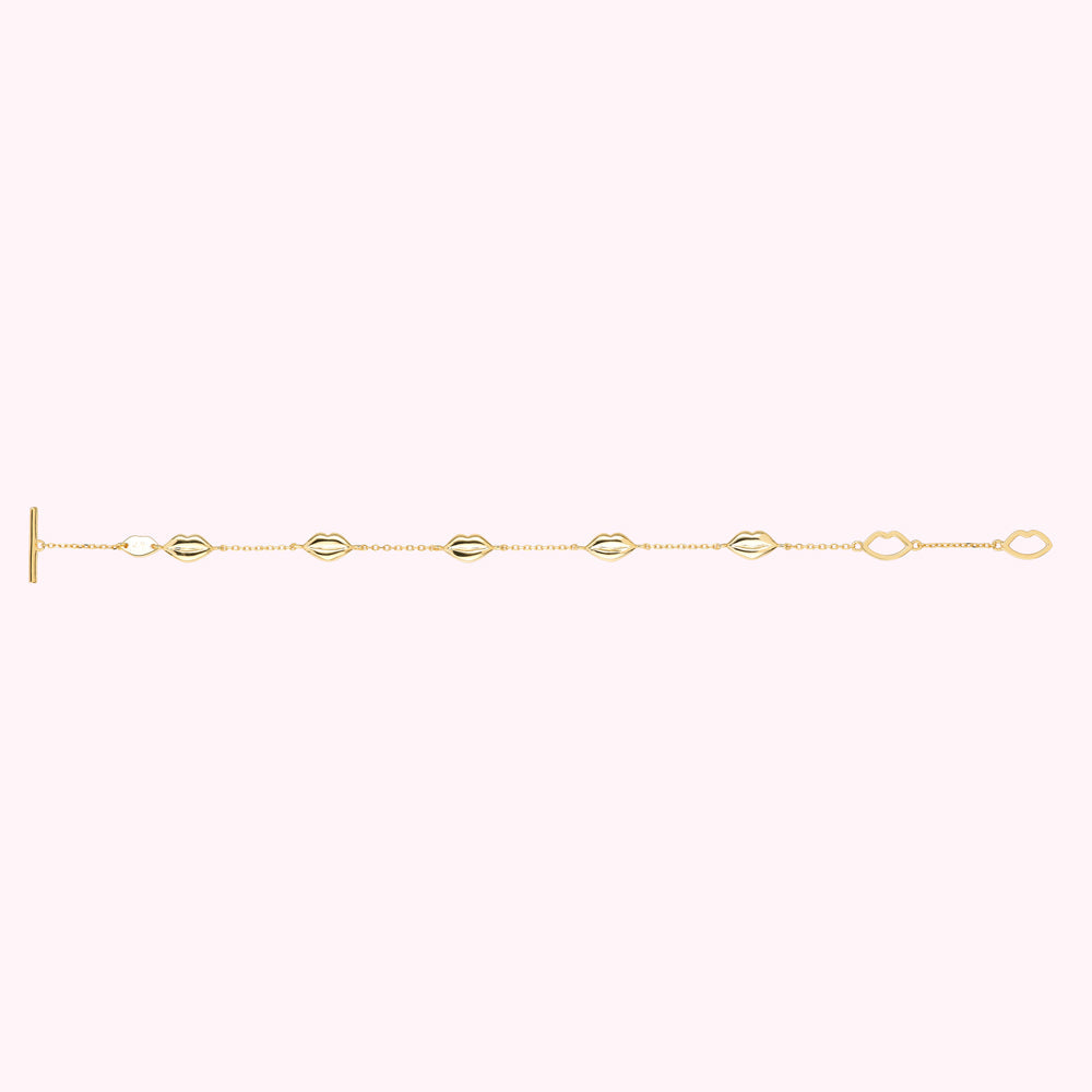 Flat shot of a gold plated sterling silver lip charm bracelet with lip shaped links.