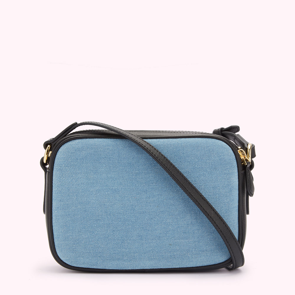 Light blue denim crossbody bag with black leather trim and strap.
