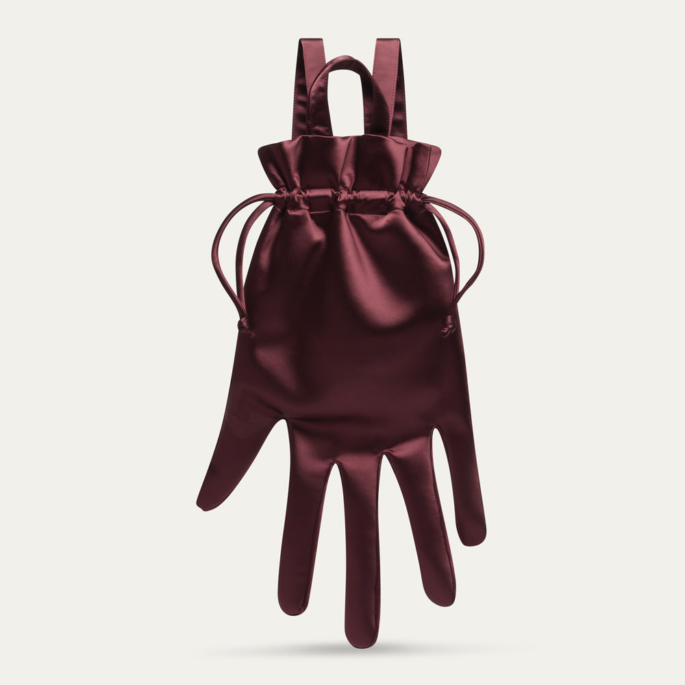 Maroon satin hand-shaped backpack with a drawstring on a light gray background