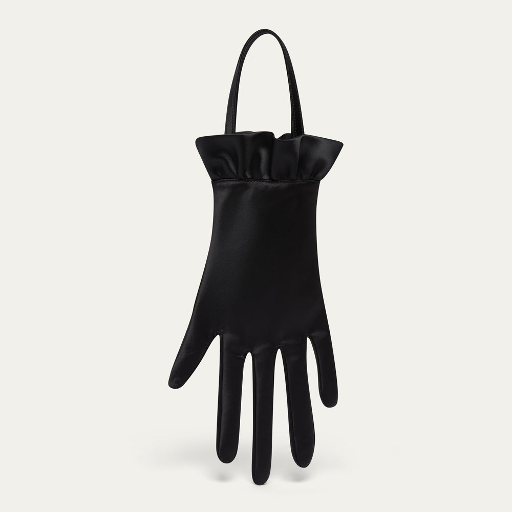 Black satin hand-shaped bag with ruffled cuff on a light gray background